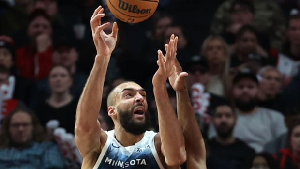 Feb 13, 2024; Portland, Oregon, USA; Minnesota Timberwolves center Rudy Gobert (27) shoots the ball over Portland Trail Blazers guard Scoot Henderson (00) in the third quarter at Moda Center.